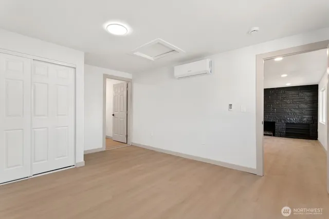 wooden floor in an empty room with a bathroom