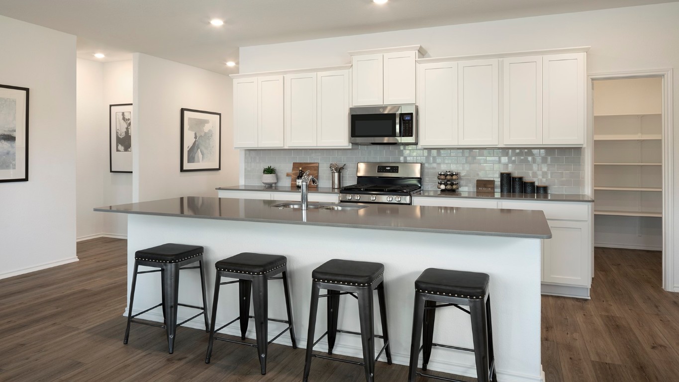 109 Arbordale Street Georgetown, TX 78628 - Photo 14 of 18 a kitchen with stainless steel appliances granite countertop a table chairs microwave and sink