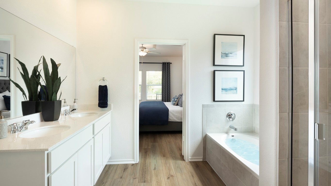 109 Arbordale Street Georgetown, TX 78628 - Photo 18 of 18 a en suite bathroom with a double vanity sink a mirror and a bathtub