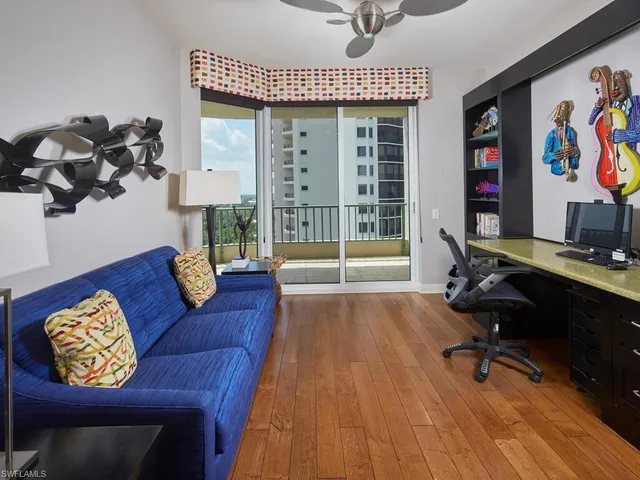 a view of a livingroom with workspace and a couch