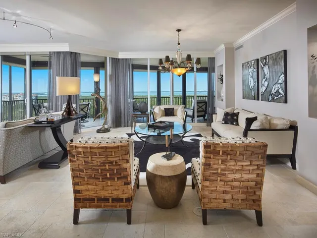 a dining room with furniture a chandelier and window
