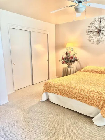 a bedroom with a bed and a painting on the wall