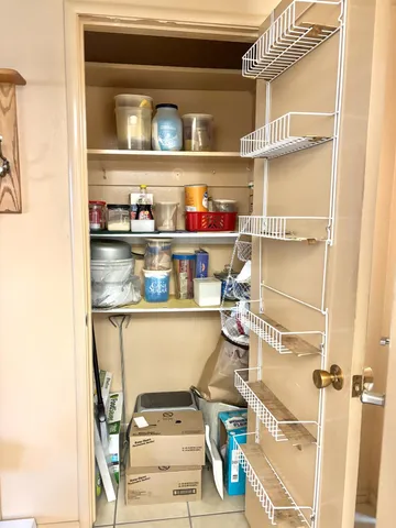 a shelf with cup and plates