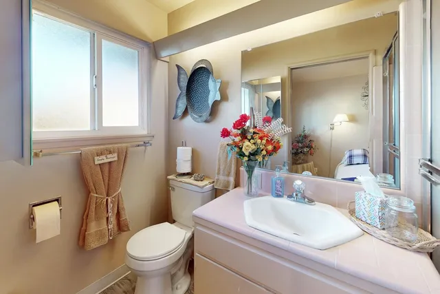 a bathroom with a toilet sink and mirror