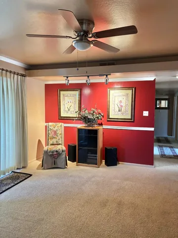 a bed room with a bed and a ceiling fan