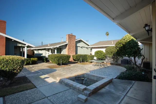 a view of a house with backyard and sitting area