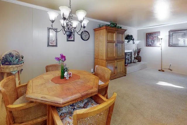 a view of a dining room with furniture and chandelier