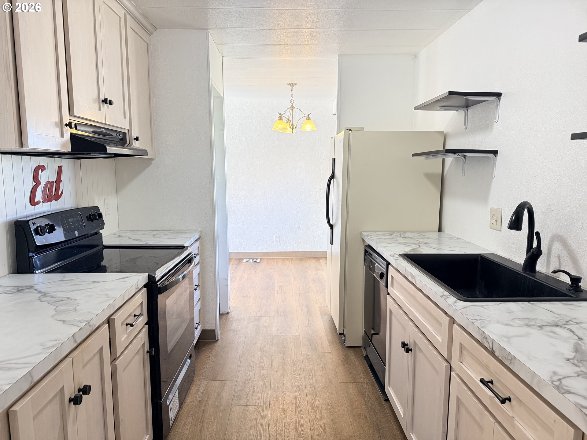 1330 West Sunland Avenue Hermiston, OR 97838 - Photo 5 of 23 a kitchen with a sink and a refrigerator