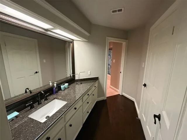 a bathroom with a double vanity sink and mirror