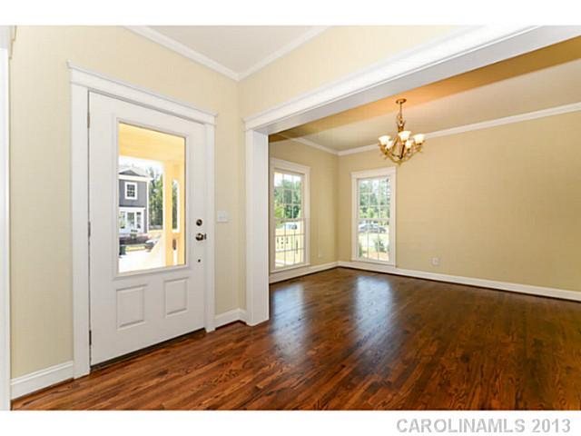 812 Elswick Court, Unit 1333 Fort Mill, SC 29708 - Photo 4 of 16 a view of an empty room with wooden floor and a window