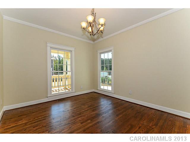 812 Elswick Court, Unit 1333 Fort Mill, SC 29708 - Photo 6 of 16 an empty room with wooden floor chandelier and windows
