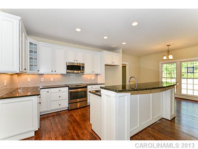 812 Elswick Court, Unit 1333 Fort Mill, SC 29708 - Photo 8 of 16 a kitchen with stainless steel appliances granite countertop a stove a sink a refrigerator and white cabinets
