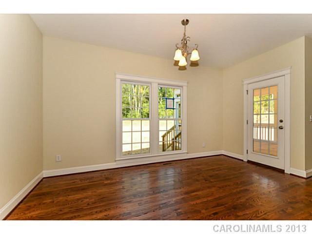 812 Elswick Court, Unit 1333 Fort Mill, SC 29708 - Photo 10 of 16 an empty room with wooden floor and windows