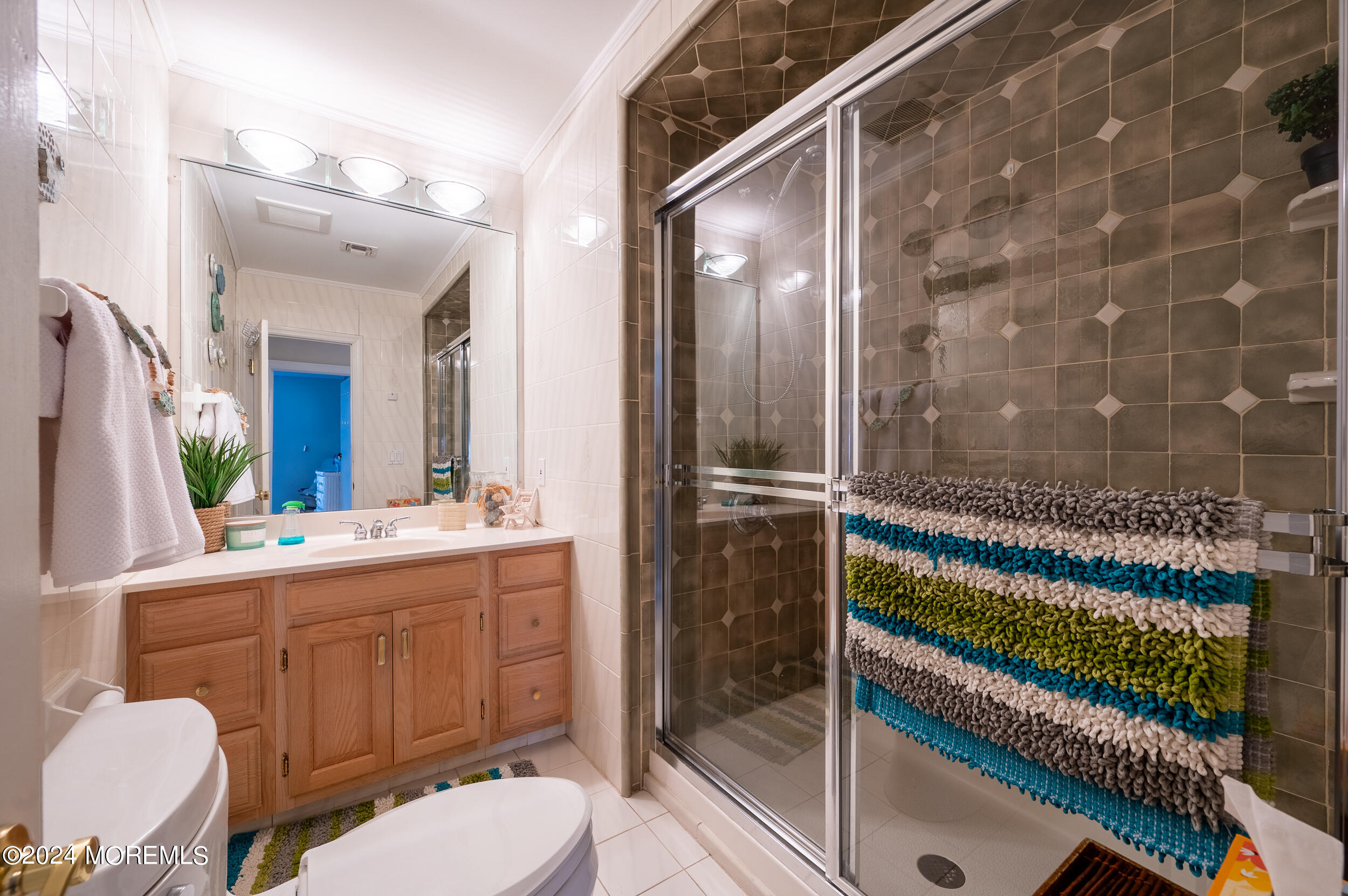 409 6th Avenue Seaside Heights, NJ 08751 - Photo 14 of 39 a bathroom with a granite countertop sink mirror vanity and toilet