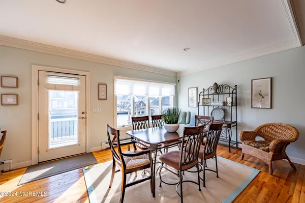 a dining room with furniture and wooden floor