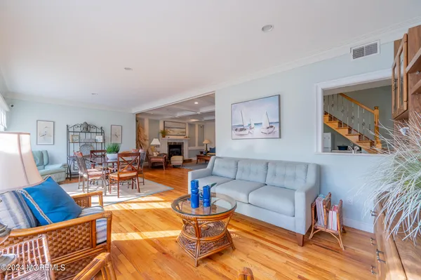 a living room with furniture a rug and a table