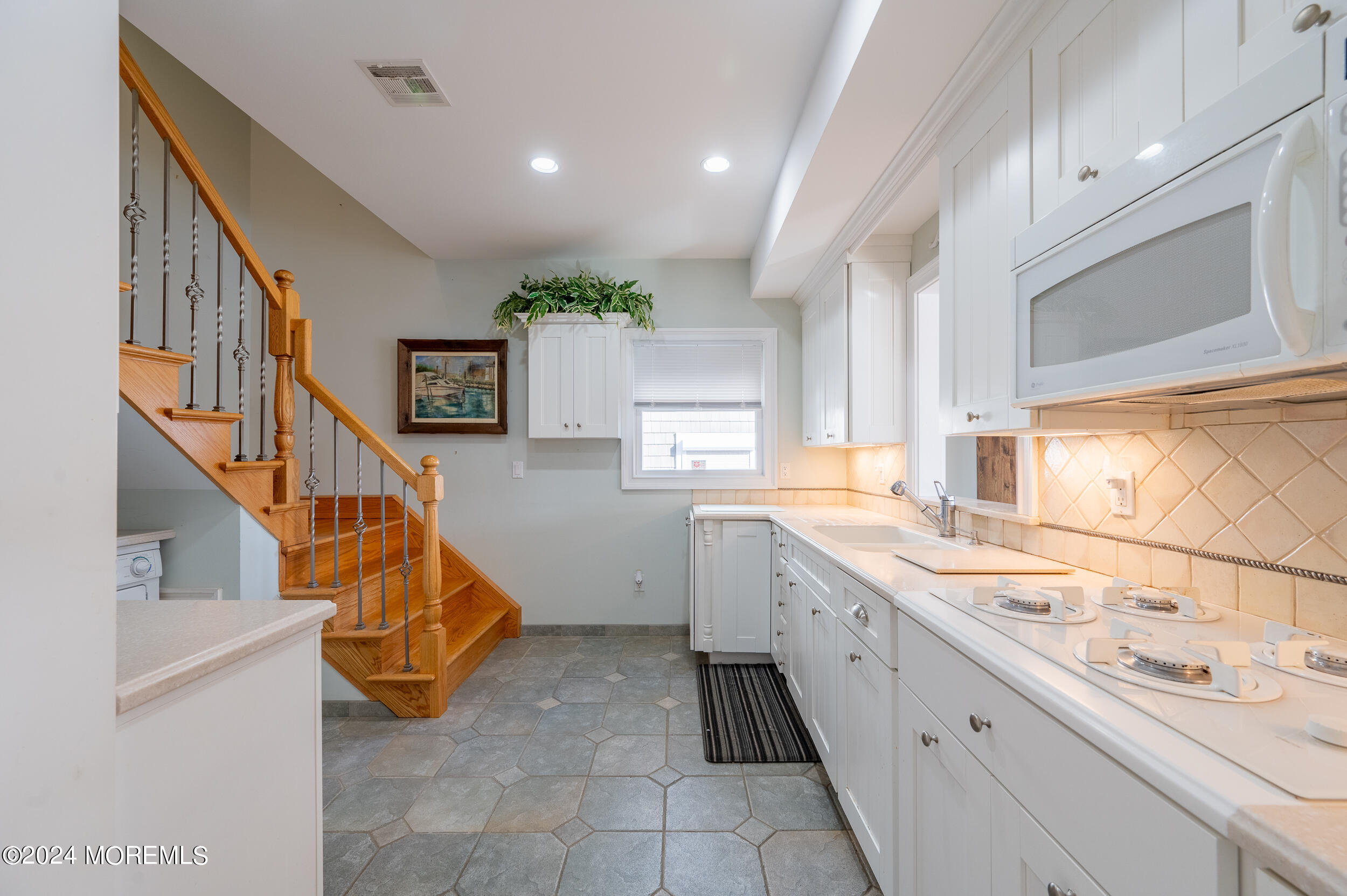 409 6th Avenue Seaside Heights, NJ 08751 - Photo 23 of 39 a kitchen with sink cabinets and window