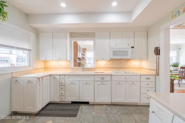 a spacious bathroom with a sink and a mirror