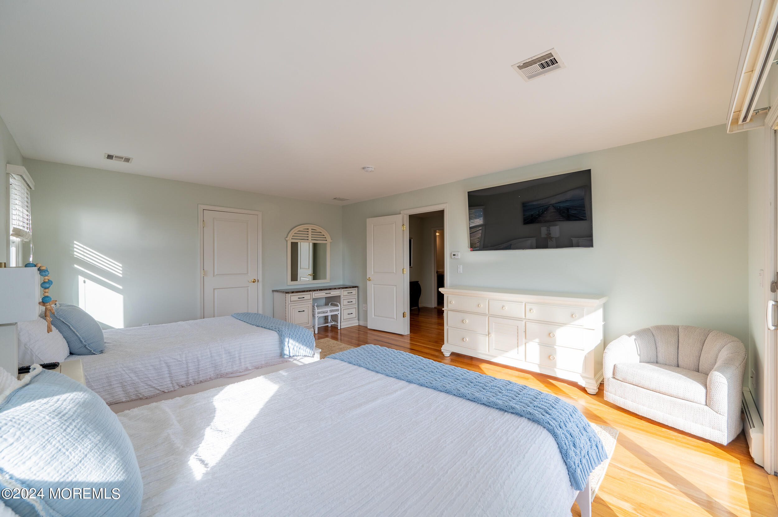 409 6th Avenue Seaside Heights, NJ 08751 - Photo 30 of 39 a bedroom with a bed and a flat tv screen on dresser