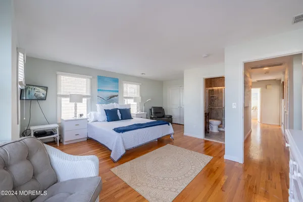 a bedroom with furniture and wooden floor