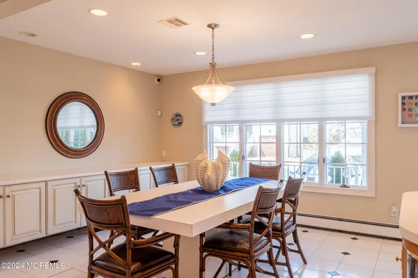 a dining room with furniture a rug and a window