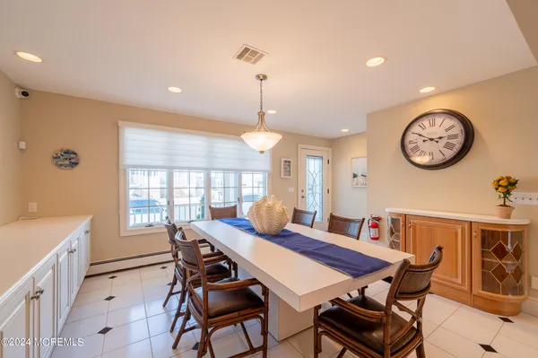 a dining room with furniture and a large window
