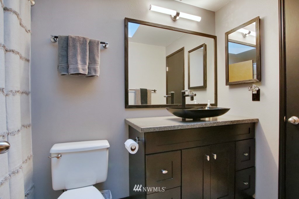 5624 Hazel Loop Southeast Auburn, WA 98092 - Photo 11 of 16 a bathroom with a toilet sink and mirror