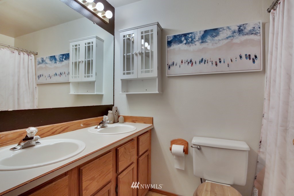 5624 Hazel Loop Southeast Auburn, WA 98092 - Photo 12 of 16 a bathroom with a sink and a mirror