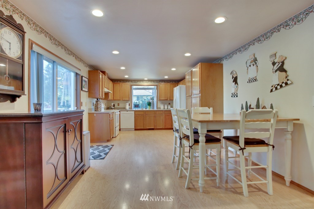 5624 Hazel Loop Southeast Auburn, WA 98092 - Photo 5 of 16 a large kitchen with a table and chairs