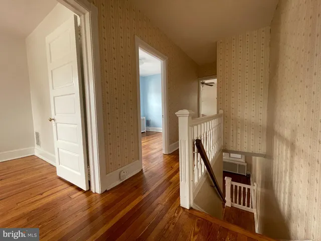 a view of hallway with wooden floor