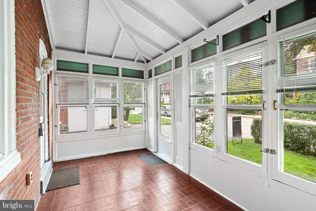 a view of an entryway with wooden floor and windows