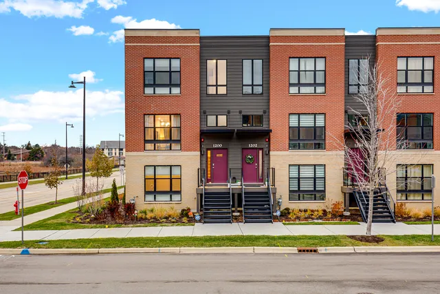 a view of a brick building next to a yard