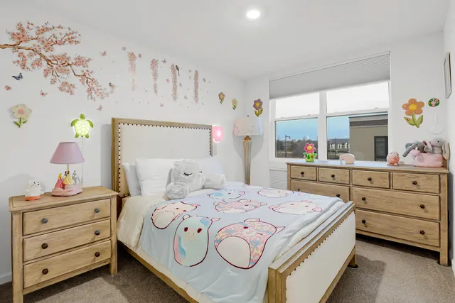 a bedroom with a bed and a dresser in it