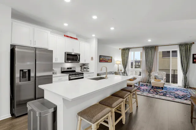 a kitchen with a sink a counter space stainless steel appliances and cabinets