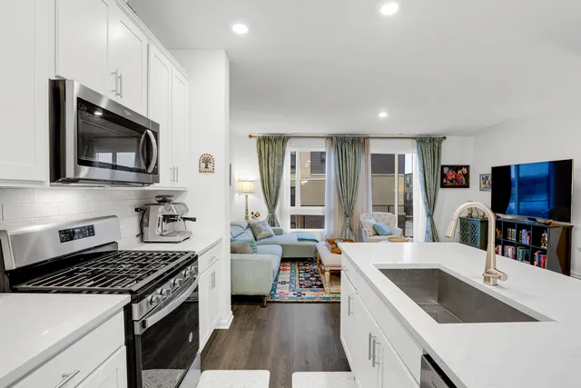 a large kitchen with a stove and a sink