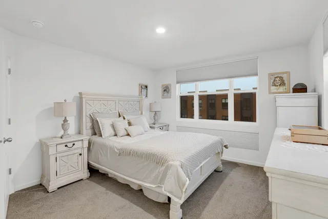 a large white bed in a white room