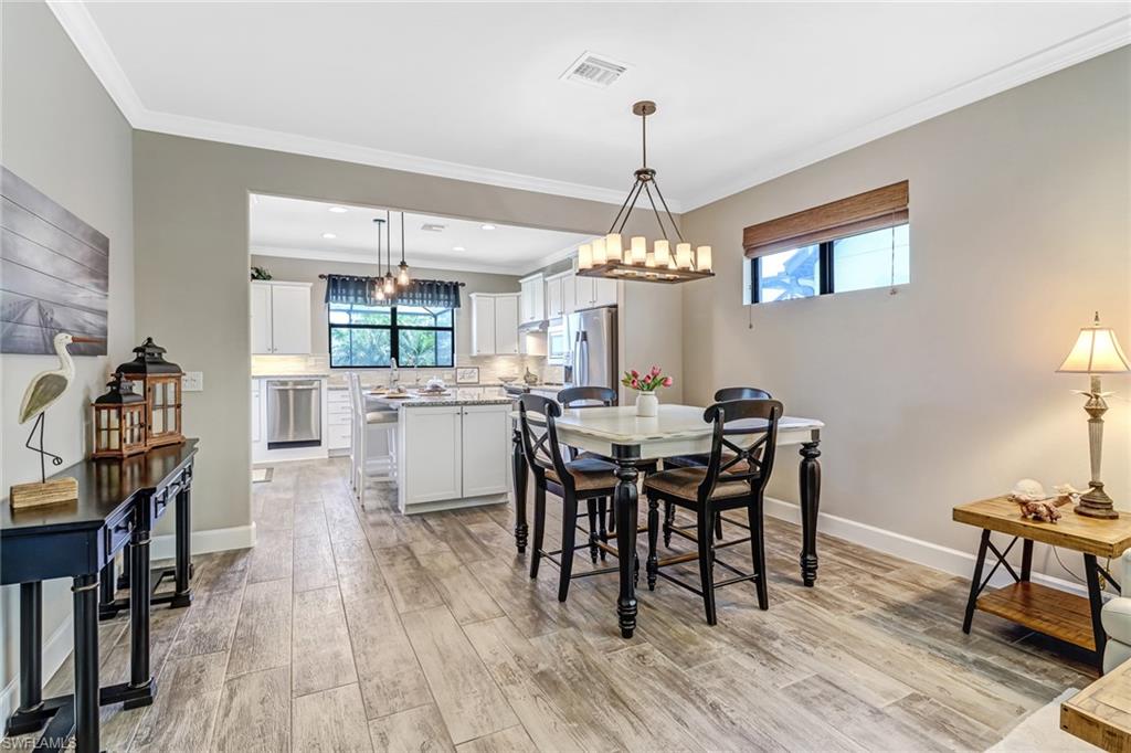 20321 Corkscrew Shores Boulevard Estero, FL 33928 - Photo 14 of 38 a view of a dining room with furniture and wooden floor