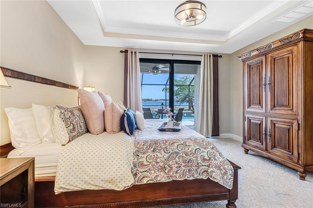 20321 Corkscrew Shores Boulevard Estero, FL 33928 - Photo 16 of 38 a bedroom with a large bed and a large window