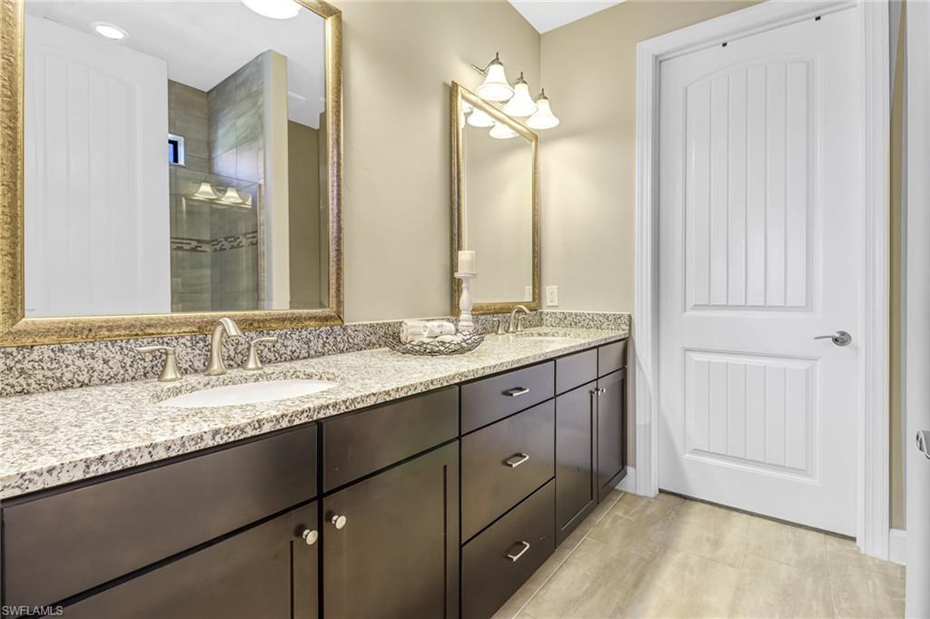20321 Corkscrew Shores Boulevard Estero, FL 33928 - Photo 17 of 38 a bathroom with a granite countertop sink and a mirror