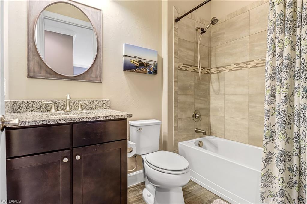 20321 Corkscrew Shores Boulevard Estero, FL 33928 - Photo 20 of 38 a bathroom with a granite countertop sink mirror toilet and bathtub