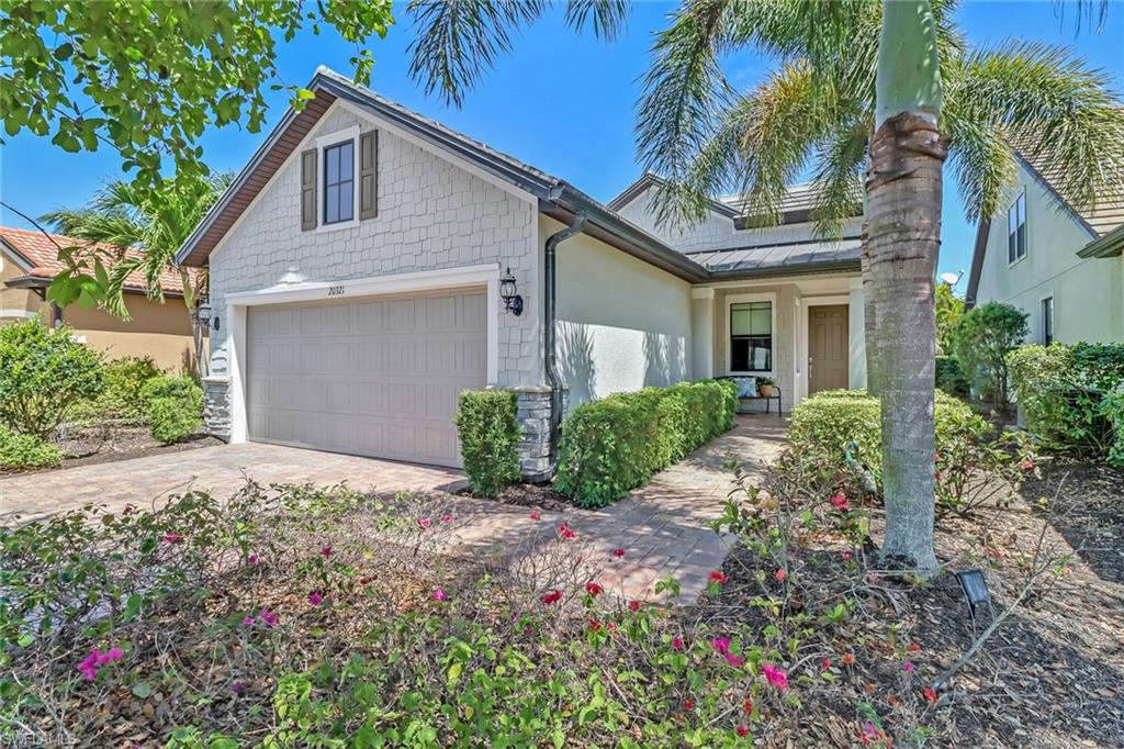 20321 Corkscrew Shores Boulevard Estero, FL 33928 - Photo 2 of 38 a front view of a house with a yard