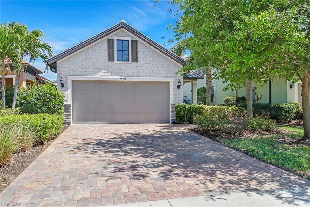 20321 Corkscrew Shores Boulevard Estero, FL 33928 - Photo 24 of 38 a front view of house with yard and trees