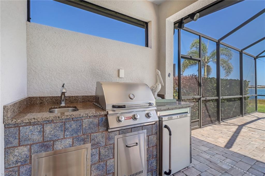 20321 Corkscrew Shores Boulevard Estero, FL 33928 - Photo 7 of 38 a kitchen with a stove top oven and cabinets
