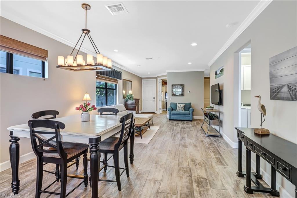 20321 Corkscrew Shores Boulevard Estero, FL 33928 - Photo 10 of 38 a view of a dining room with furniture window and wooden floor
