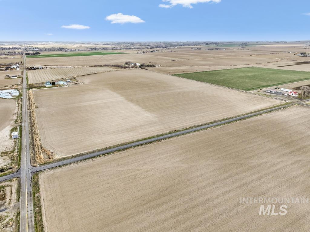 3900 North (52 /- Acres) Filer, ID 83328 - Photo 2 of 29 Aerial view of sparsely populated area with rows of crops
