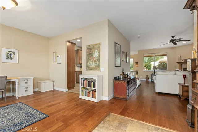a living room with stainless steel appliances kitchen island granite countertop furniture and a rug