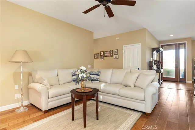 a large kitchen with stainless steel appliances lots of counter space and a wooden floor