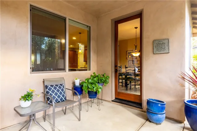 a view of an outdoor sitting area with chairs and backyard