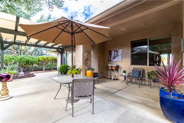 a view of a chair and table in patio with a fire pit and a fire pit