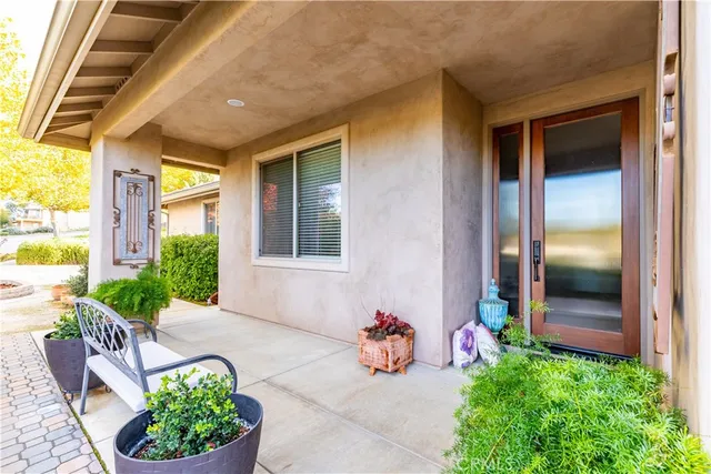 a view of a porch with furniture and plants